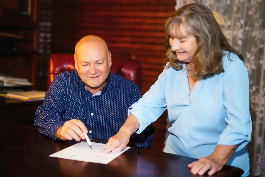 Attorney Larry Simmons reviewing probate contracts with attorney Marguerite Stricker
